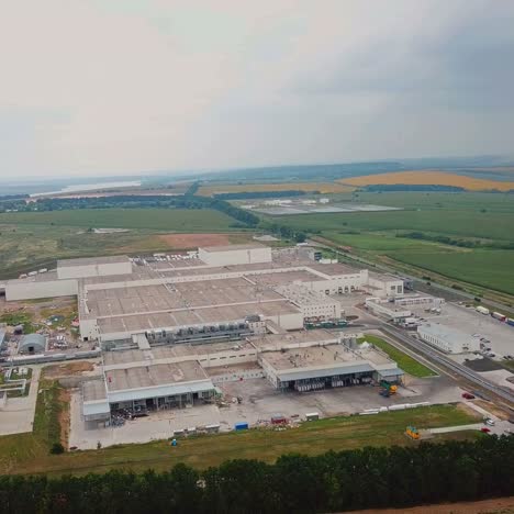 aerial view of modern industrial building surrounded by green fields. large modern production plant