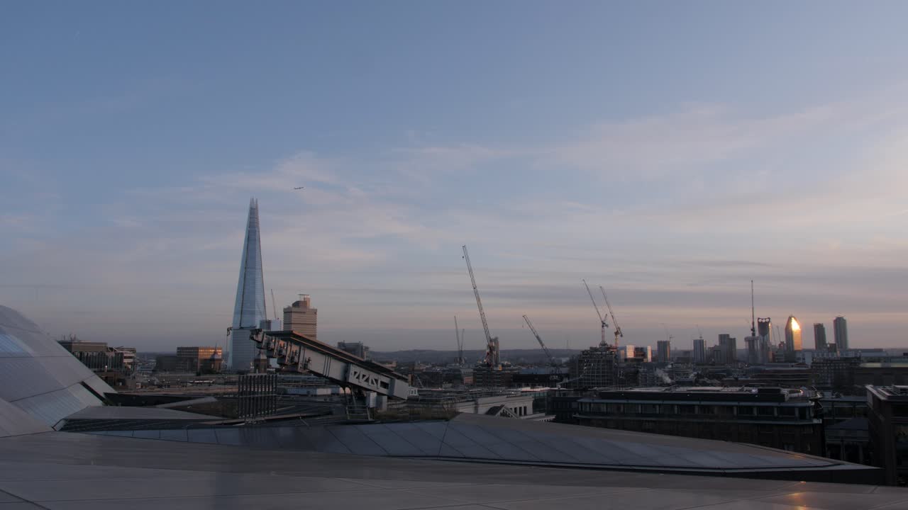 A plane flying over the Shard -- View from the top roof