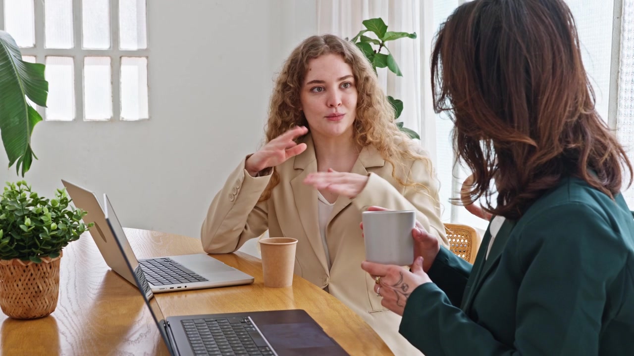 Due donne d'affari discutono di lavoro in un ufficio moderno