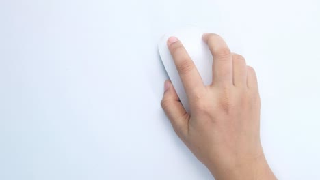 hand holding a white computer mouse