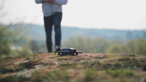 person prepare to take off fpv drone from brown outdoor surface, czechia