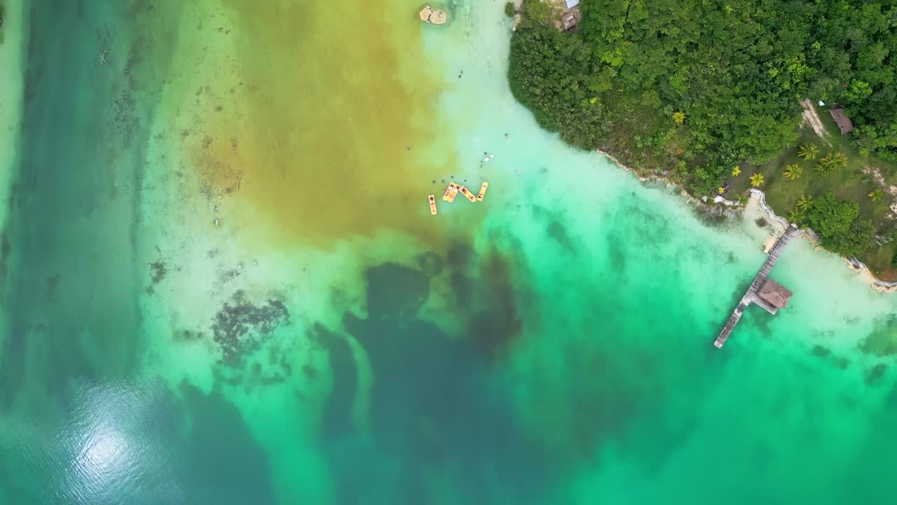 Tropical Coastline Buildings, Clear Turquoise Water, Aerial Reveal View