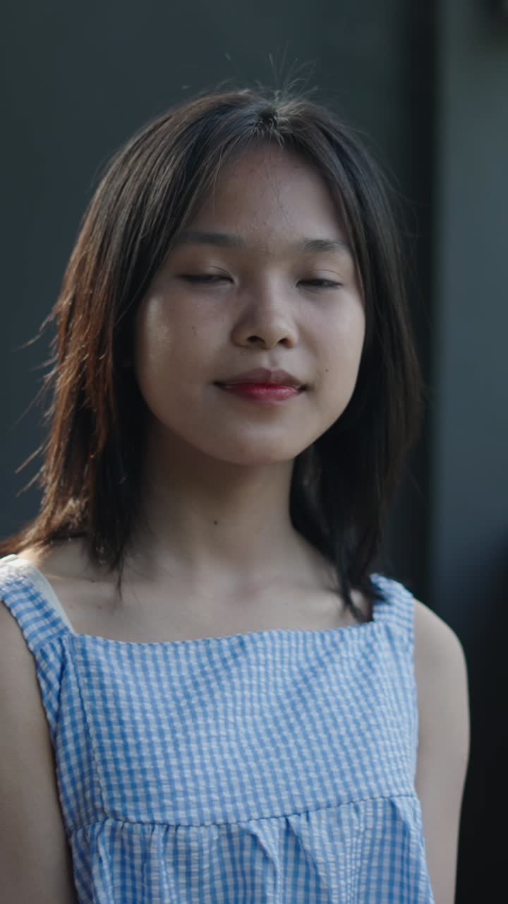 Portrait of a young woman in a gingham dress