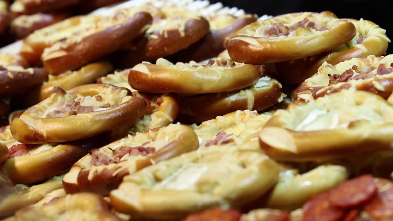 Pretzels with ham and cheese, street food market display