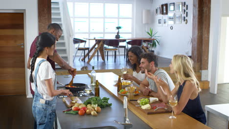 Friends-Talk-To-Guests-Whilst-Making-Food-For-Dinner-Party