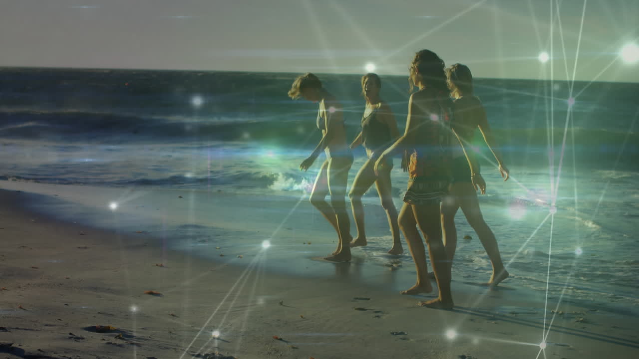 animación de redes de conexiones sobre un grupo feliz de amigos divirtiéndose, caminando por la playa