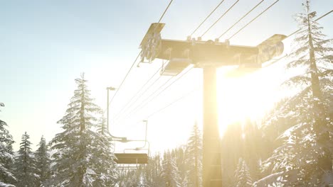 empty ski lift. chairlift silhouette on high mountain over the forest at sunset