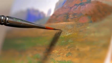 Shallow depth of field of artists painting with brown green oil paint