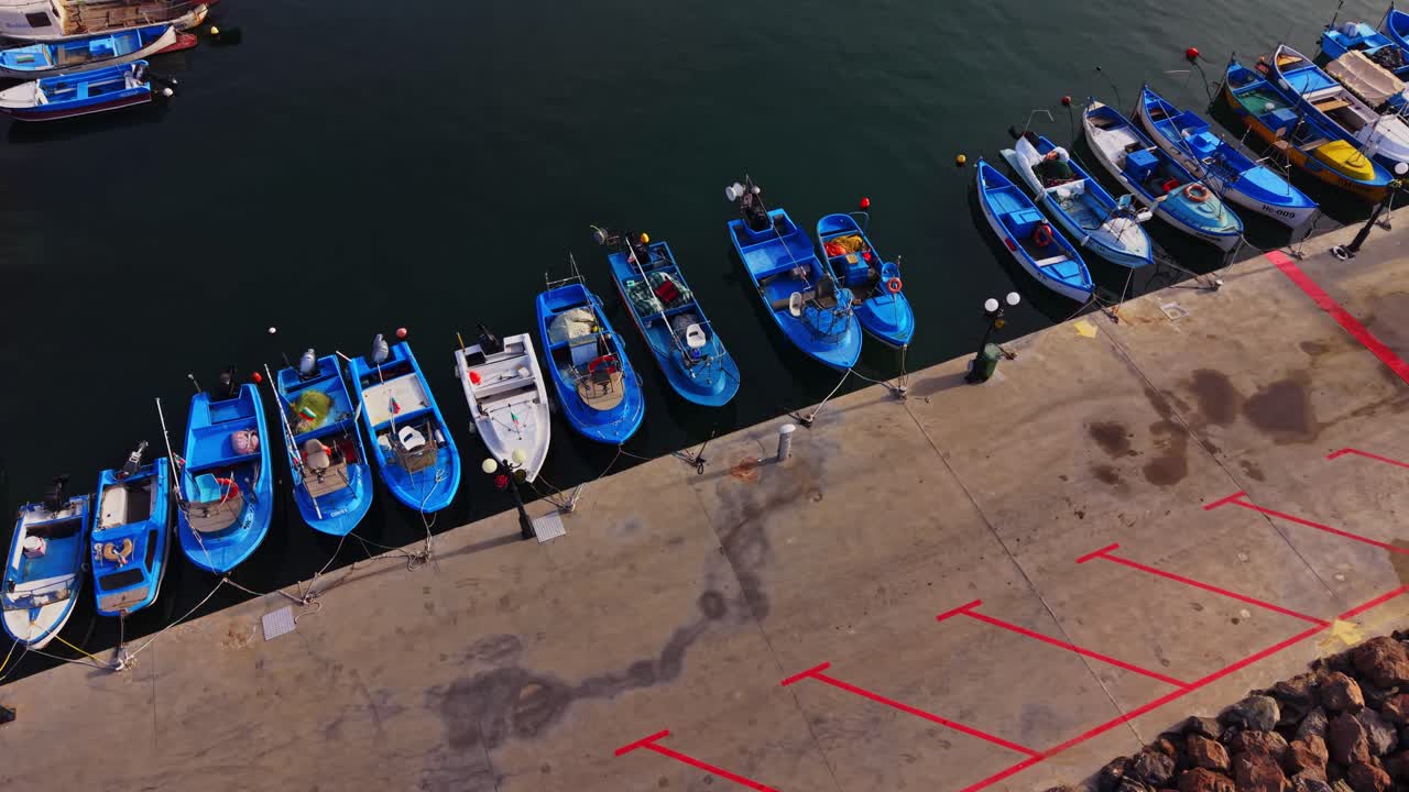 Blue fishing boats lined up at a dock in Bulgaria near the sea