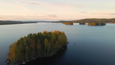 drone shot flying sideways over lake naren, sweden during sunset.