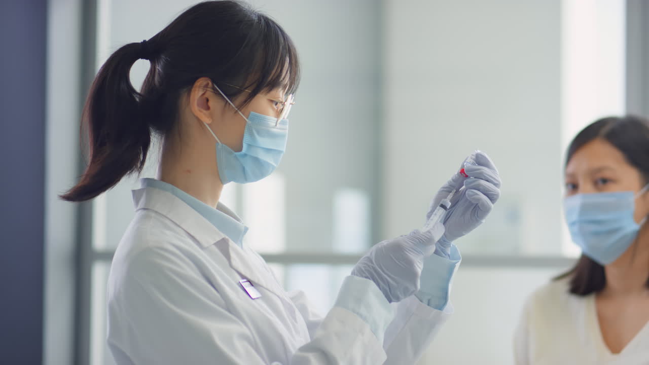 Female Doctor Preparing Vaccine for Patient