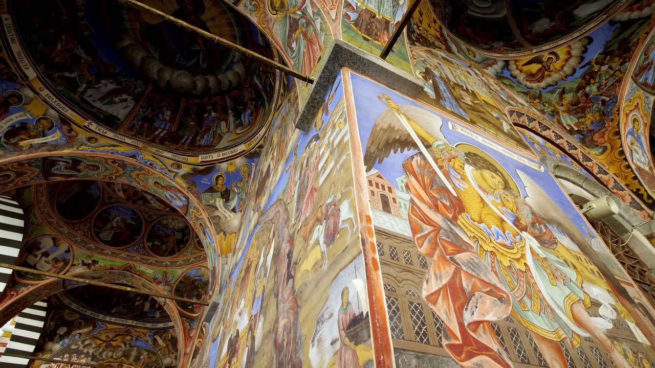 Interior view of Rila Monastery in Bulgaria, featuring intricate frescoes and sacred paintings, Orthodox art and rich cultural heritage low angle view
