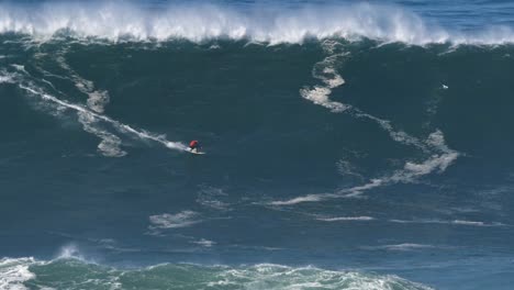 2020 slow motion of a big wave surfer carlos burle riding a monster wave in nazaré, portugal