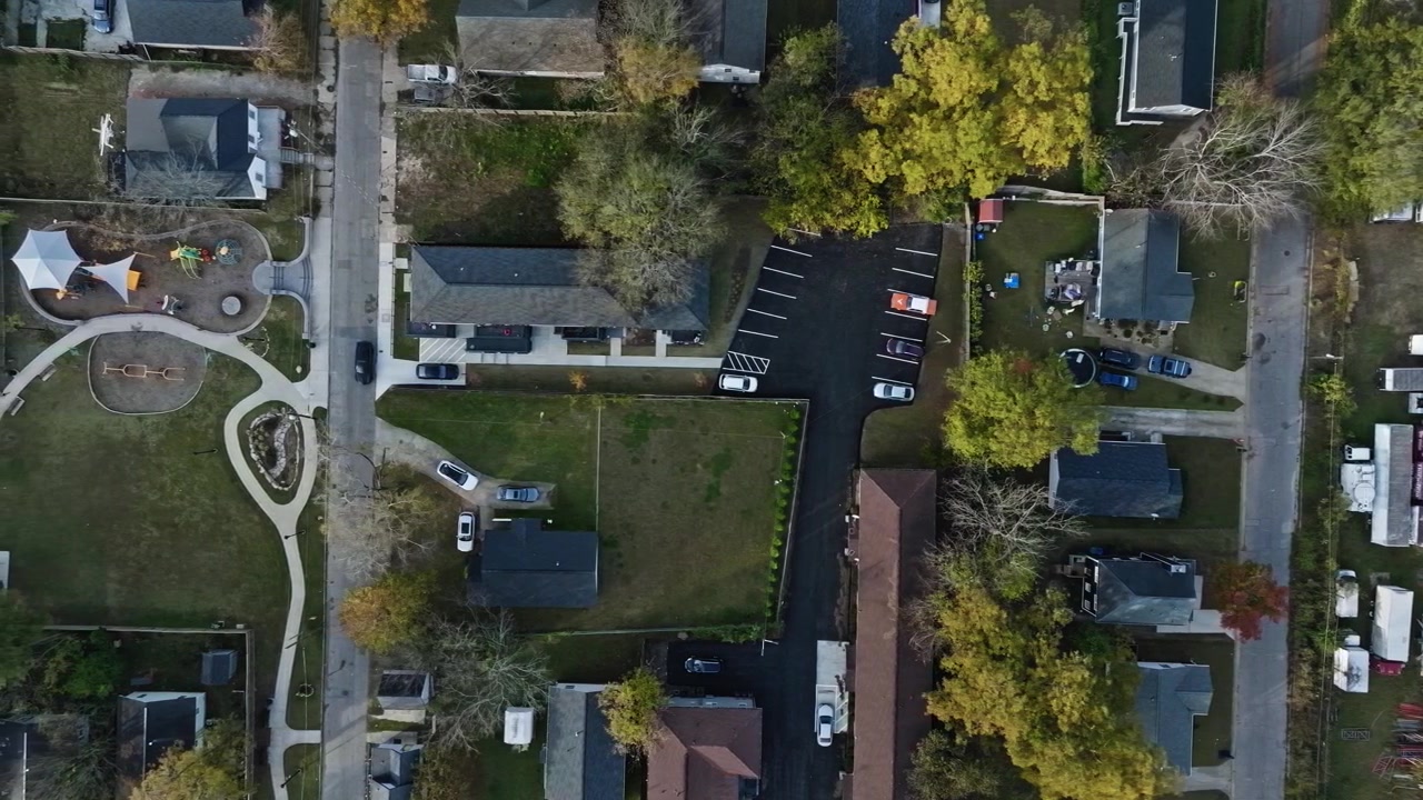 Aerial top down shot of American Neighborhood with colorful trees during sunny day, Georgia, USA - Atlanta City Suburb Area. Colored trees with multicolored leaves in fall.