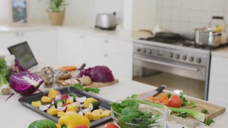 General-view-of-kitchen-with-vegetables-and-tablet-on-countertop