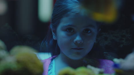 cute-little-girl-in-aquarium-looking-at-fish-curious-child-watching-colorful-sea-life-swimming-in-tank-learning-about-marine-animals-in-underwater-ecosystem-inquisitive-kid-at-oceanarium