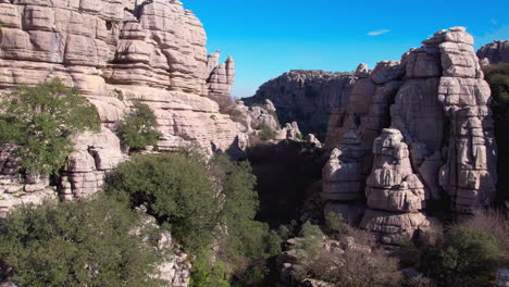 Aerial-dolly-shot-between-the-rocky-formation-at-the-nature-reserve-in-El-Torcal-de-Antequera,-Malaga,-Andalusia,-Spain