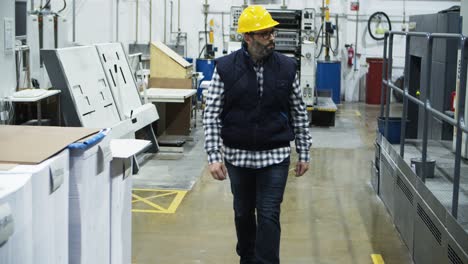 front view of printing worker walking at factory