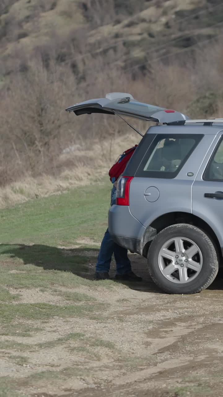 Man with Car in Rural Setting
