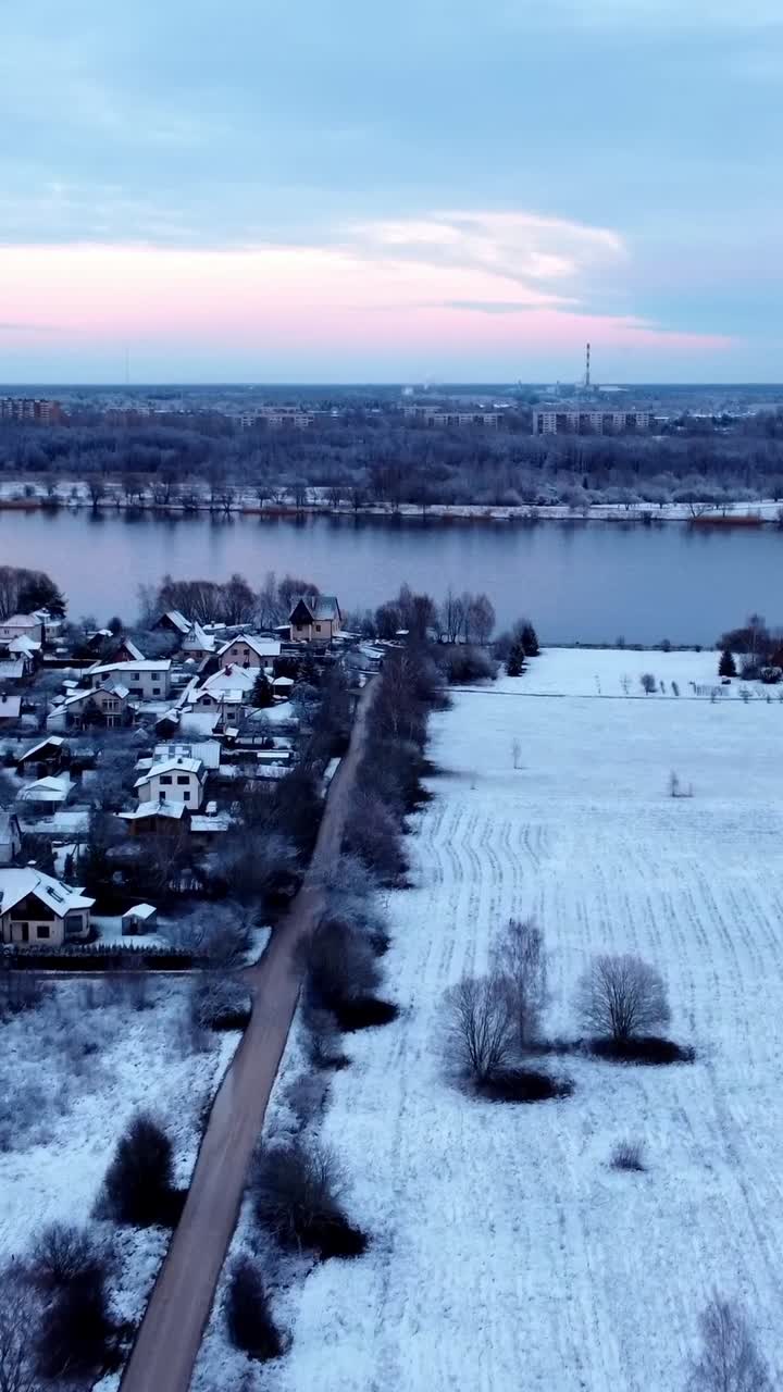 Snow covered Riga city suburbs of Katlakalns, aerial vertical view