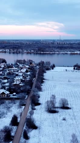 snow covered riga city suburbs of katlakalns, aerial vertical view