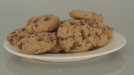 dolly right of chocolate chip cookies on a white plate