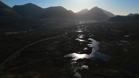 sunrise reflecting off loch caol with mountain silhouettes of red cuillin at sligachan isle of skye