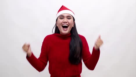 surprised amazed young asian woman in christmas costume standing clenching hand, good price in christmas season, successful