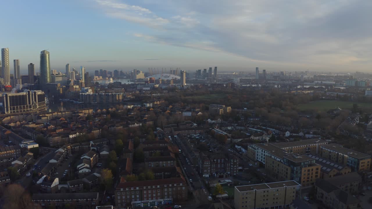 Dolly forward drone shot towards O2 arena over Isle of Dogs at sunrise London