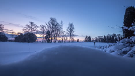 time lapse of clouds passing over a snow covered landscape at sunset