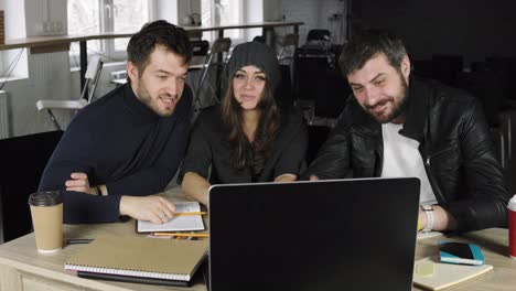 team of young professionals having a conference call in a creative office. business discussion. coffee cups on the table. shot in 4k