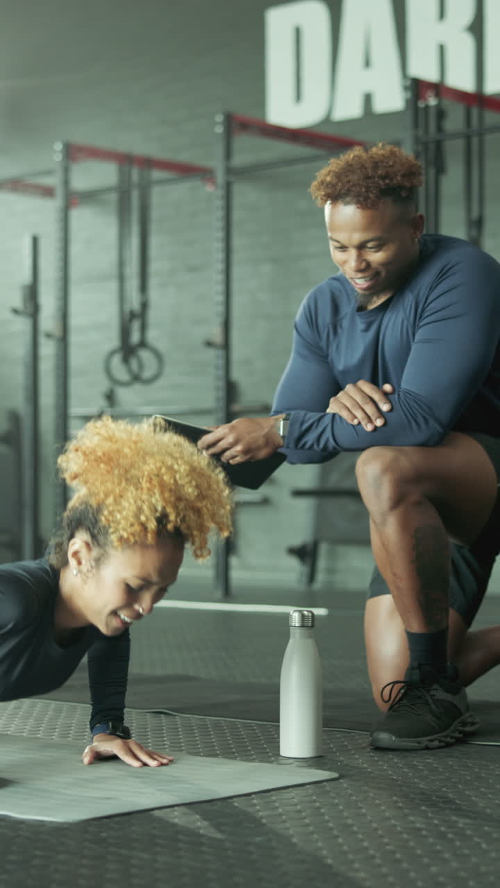 Personal Trainer Coaching Woman Doing Push-ups in a Modern Gym