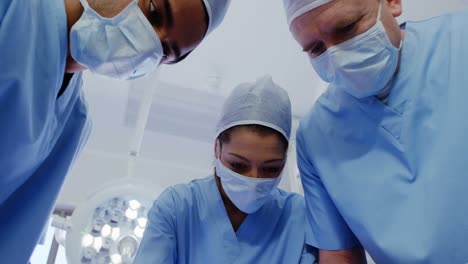 surgery team operating a patient in an operating room