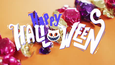 happy halloween text animation over colorful candies on orange background