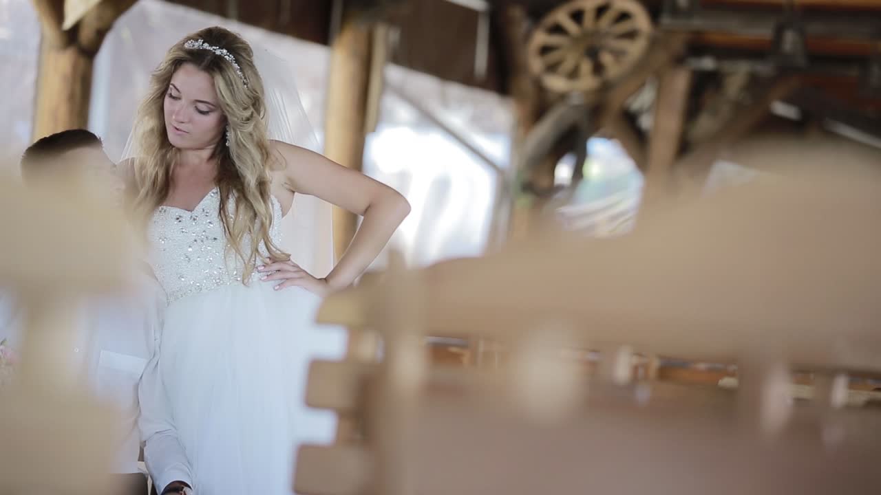 Romantic Bride And Groom Sitting At Alcove. Portrait of romantic bride and groom sitting at alcove at sunny day