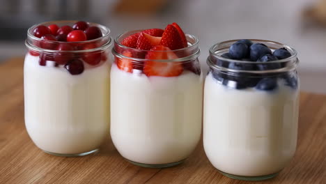 Three Jars of Yogurt with Mixed Berries