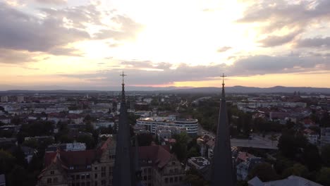 aerial view of historic gothic old town landscape with cathedral church towers during sunset, freiburg, germany
