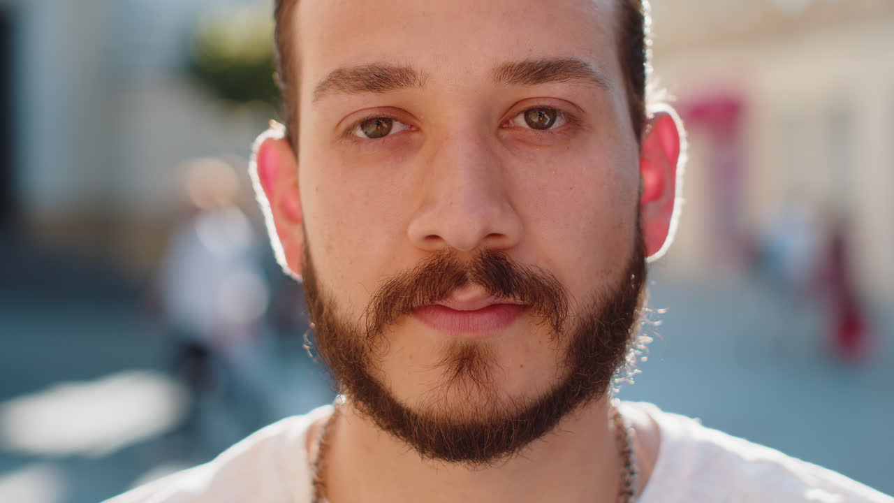 Happy young man smiling looking away dreaming resting good news feel satisfied in city street