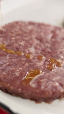 raw hamburger patty on a plate