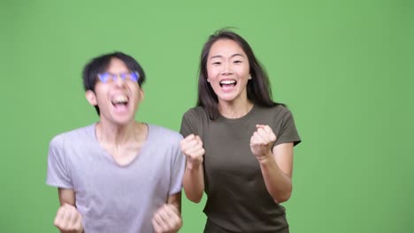 young asian couple getting good news together