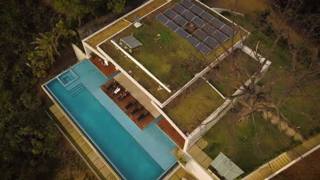 beautiful aerial view of a modern tropical home with an infinite pool
