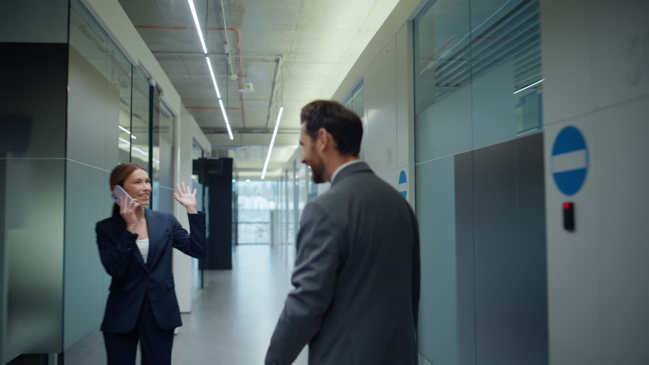 Back view boss going glass hall in office building. Director looking watches