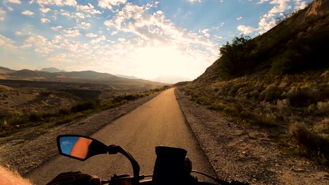 riding a bicycle toward the sunrise with scenic views of the mountains and valleys