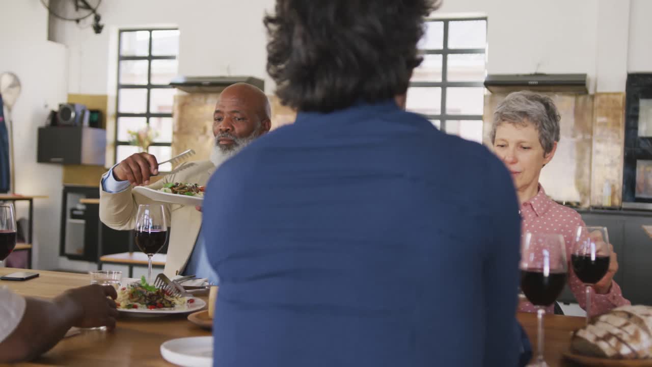 Friends eating pasta together