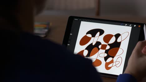 woman drawing on tablet with digital pen using smart app