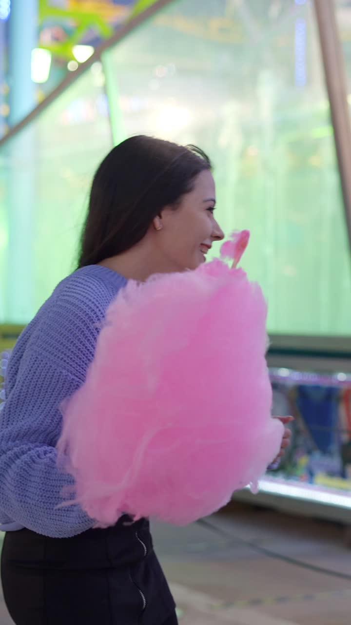 Friends enjoying cotton candy at an amusement park
