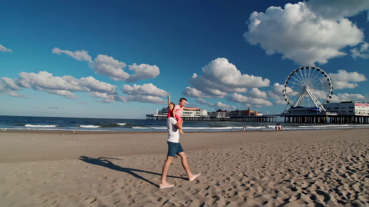 Father carrying children on a sunny beach with a pier and Ferris wheel in the background