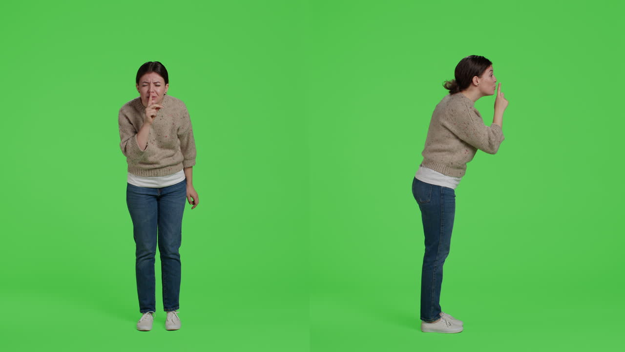 Woman gesturing silence on green screen
