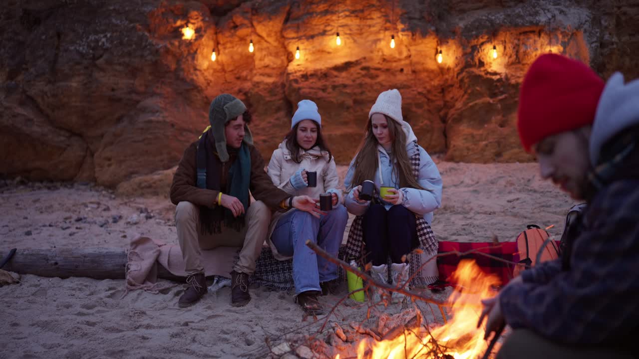 Friends Enjoying a Nighttime Campfire on the Beach