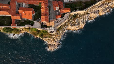 bird's eye view of rocky cliff, buza beach and basketball court in dubrovnik, croatia. - aerial shot